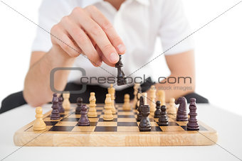 Focused businessman playing chess solo