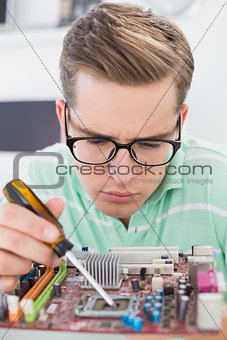 Technician working on broken cpu with screwdriver
