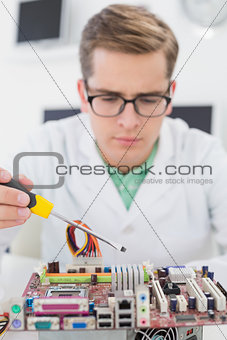 Technician working on broken cpu with screwdriver
