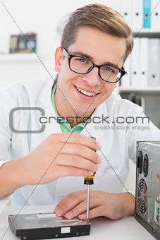 Technician working on broken hardware with screwdriver