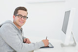 Casual man working at desk with computer and digitizer