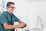 Casual businessman working at desk with computer and digitizer