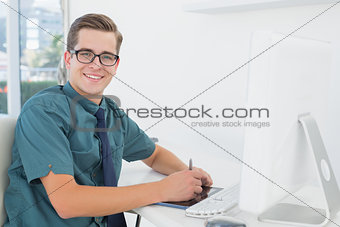 Casual businessman working at desk with computer and digitizer