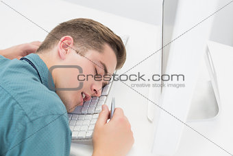 Casual businessman sleeping at his desk