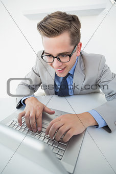 Excited businessman working on laptop