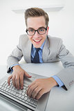 Excited businessman working on laptop