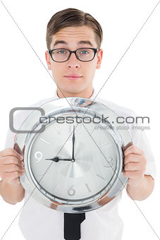 Nerdy businessman showing clock to camera