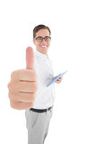 Nerdy businessman holding his digital tablet showing thumbs up