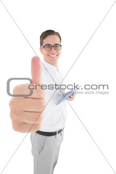 Nerdy businessman holding his digital tablet showing thumbs up