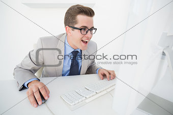 Excited businessman working on computer