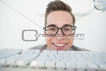 Smiling businessman working on computer