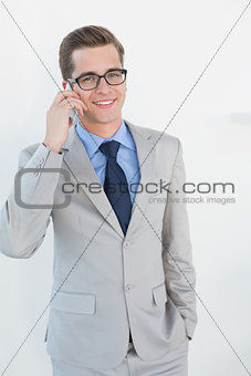 Nerdy businessman talking on phone