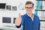 Smiling technician looking at camera showing thumbs up