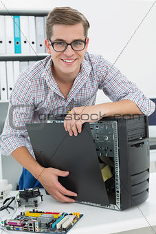 Young technician working on broken computer
