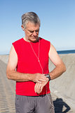 Active senior man jogging on the pier