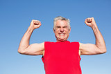 Active senior man cheering in red tank top