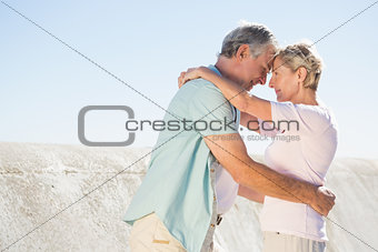 Happy senior couple embracing on the pier