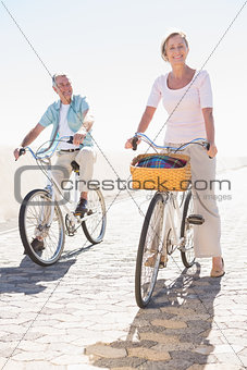Happy senior couple going for a bike ride