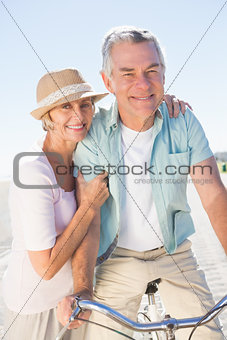 Happy senior couple going for a bike ride