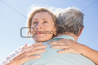Senior woman hugging her partner