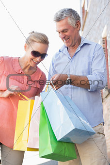 Happy senior couple looking at their purchases