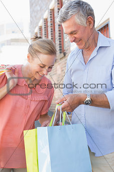 Happy senior couple shopping in the city