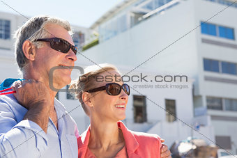 Happy senior couple holding shopping bags