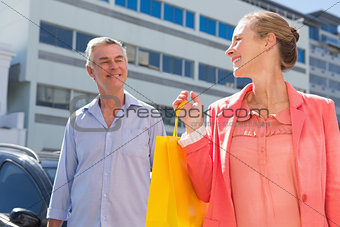 Happy senior couple shopping in the city