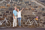 Happy senior couple going for a bike ride in the city
