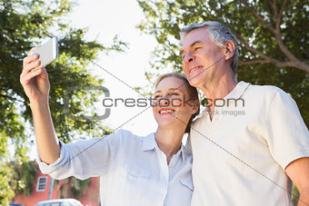 Happy senior couple posing for a selfie