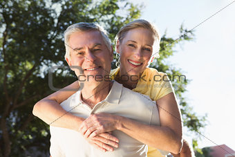 Happy senior man giving his partner a piggy back
