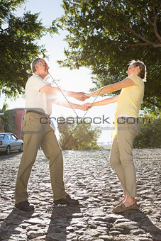 Happy senior couple holding hands