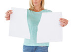 Serious woman holding torn sheet of paper