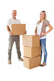 Happy couple smiling at camera with moving boxes