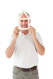 Happy man holding house outline over face