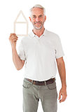Happy man holding house outline