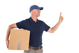 Happy delivery man holding cardboard box and pointing up