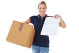 Happy delivery woman holding cardboard box and clipboard