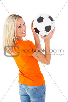 Football fan holding ball in orange tshirt