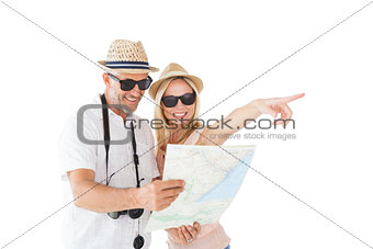 Happy tourist couple using map and pointing