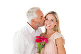 Affectionate man kissing his wife on the cheek with roses