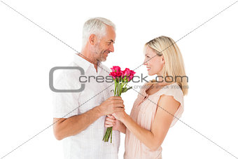 Affectionate man offering his partner roses