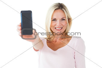 Happy blonde showing her smartphone