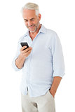 Smiling man sending a text message