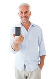 Smiling man showing smartphone to camera