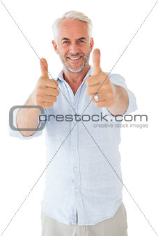 Smiling man showing thumbs up to camera