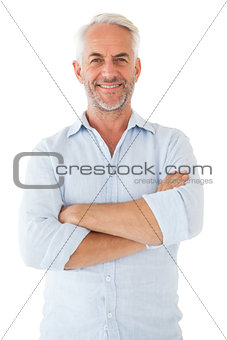 Smiling man posing with arms crossed