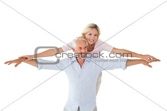 Smiling couple posing with arms out