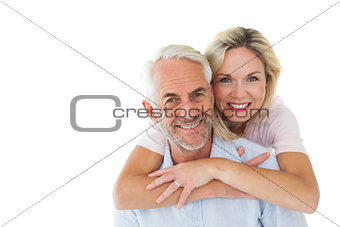 Smiling couple embracing and looking at camera