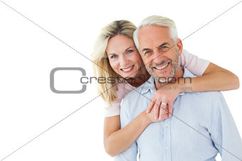 Smiling couple embracing and looking at camera